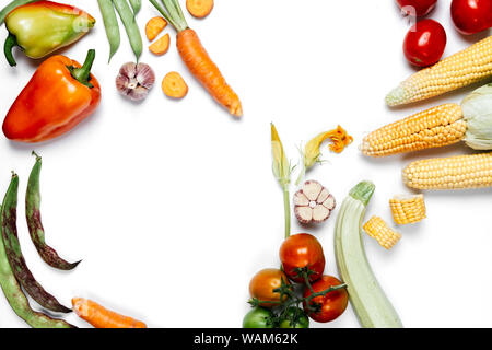 Pattern made of vegetables. Healthy eating concept. Tomatoes, onion, carrot, garlic, red beet, pepper, maize and green haricot on white background. Fl Stock Photo