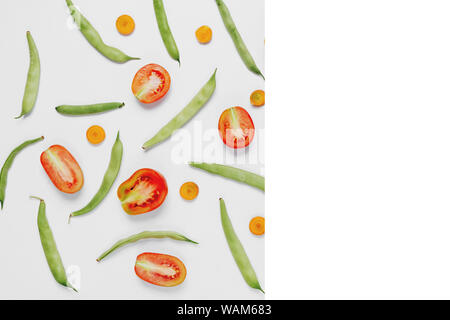 Pattern made of haricot, tomatoes, carrot on white background .Flat lay, top view, copy space. Food concept. Stock Photo