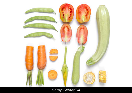 Pattern made of haricot, tomatoes, corn, carrot, zucchinion white background . Flat lay, top view, copy space. Healthy eating concept. Stock Photo