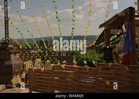 A view of a rural French village scene and surrounding hills and countryside from a patio garden Stock Photo
