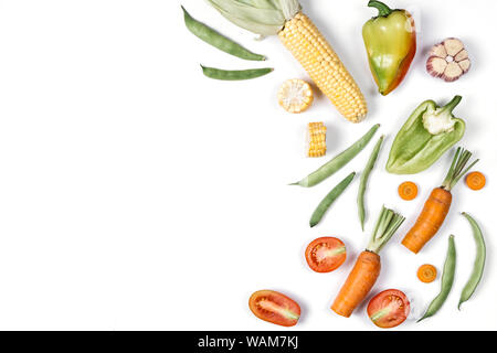 Pattern made of haricot, tomatoes, pepper, carrot, garlic, maize, zucchini and onion. Organic food background. Flat lay, top view, copy space. Healthy Stock Photo