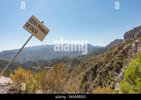 Sign private hunting area in Natural park Sierras de Tejeda, Almijara y Alhama, in Andalusia, Spain. Stock Photo