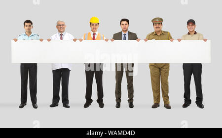 Group of professionals with different occupations showing placard Stock Photo