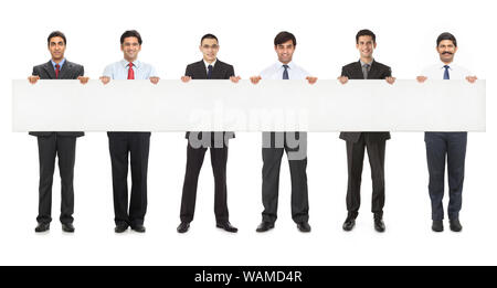 Business executives standing together and showing placard Stock Photo