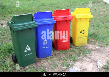 4 types of waste bins for waste sorting. Garbage disposal by separating waste into categories. Stock Photo