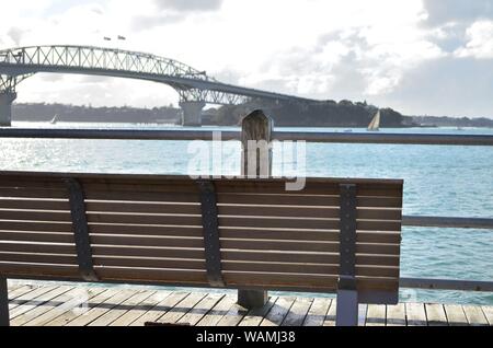 Sit and enjoy the view of Auckland Harbour and Bridge, New Zealand Stock Photo