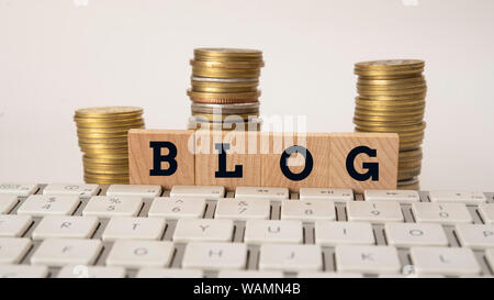Text of Blog on wooden blocks with Coin Stack Stock Photo
