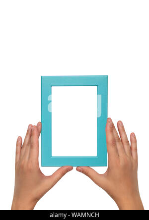 Blue photo frame in female hands. Empty blue frame template. Stock Photo