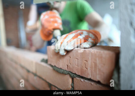 Male hands putting bricks Stock Photo