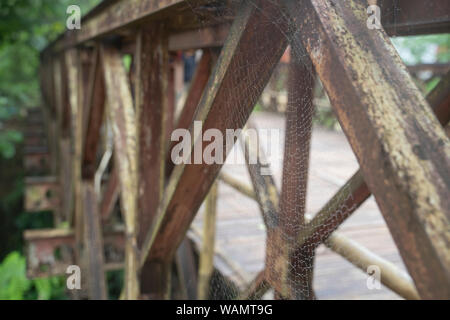 Cobweb, Spider web with water drop was built on these ancient iron bridges. Stock Photo