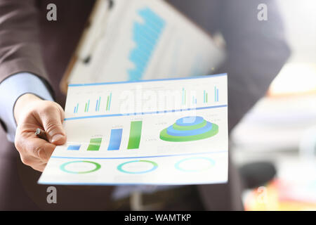 Person Analyzing Business Proceeds Using Graph Stock Photo
