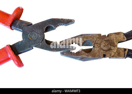 two used rusty worn pliers biting each other on a white background Stock Photo