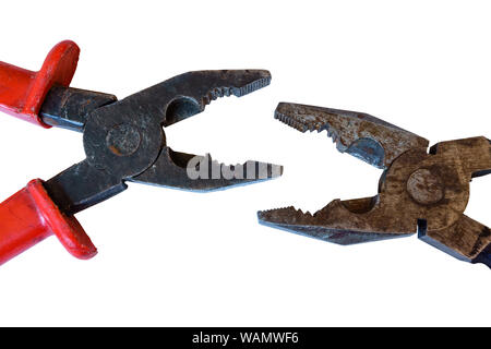 two used rusty worn pliers biting each other on a white background Stock Photo