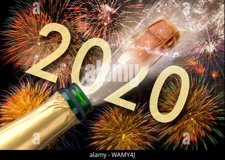 Happy new year 2020 with firework and splashing bottle of champagne Stock Photo