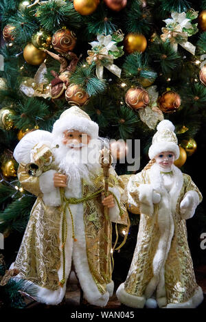 Christmas figurine on the background of the Christmas tree. Stock Photo