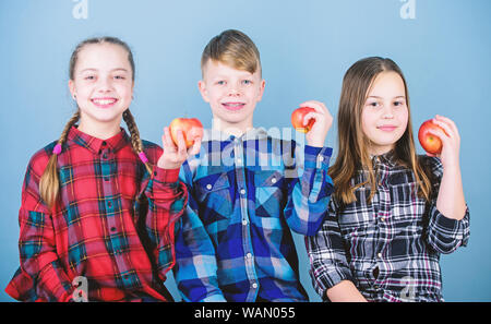 School snack time. Having tasty snack. Boy and girls friends eat apple snack. Teens with healthy snack. Apple fruit has numerous benefits. Vitamin nutrition concept. Eat fruit and be healthy. Stock Photo