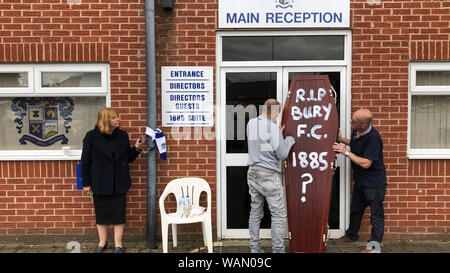 Former director Joy Hart, who has handcuffed herself to the main stand at ailing Bury FC, pleads for help to save the club as fans deliver a symbolic coffin to the front door. Stock Photo