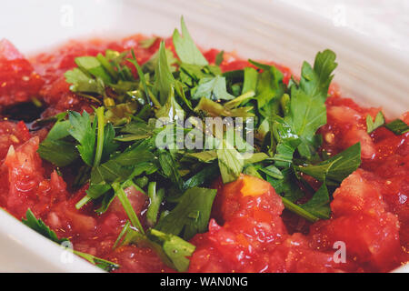 Acili ezme - turkish salad with fresh tomatos, parsley, greens, olive oil and spice. Selective focus Stock Photo