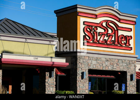 A logo sign outside of a Sizzler restaurant location in Orem, Utah on July 29, 2019. Stock Photo