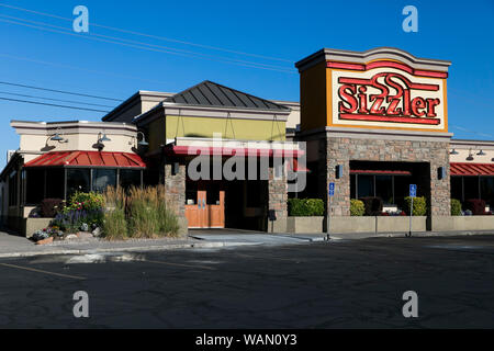 A logo sign outside of a Sizzler restaurant location in Orem, Utah on July 29, 2019. Stock Photo