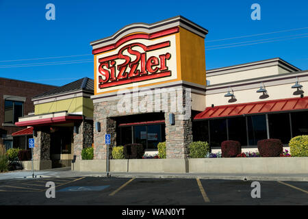 A logo sign outside of a Sizzler restaurant location in Orem, Utah on July 29, 2019. Stock Photo