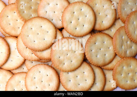 Biscuits cracker background. Crackers lay on the table. Stock Photo