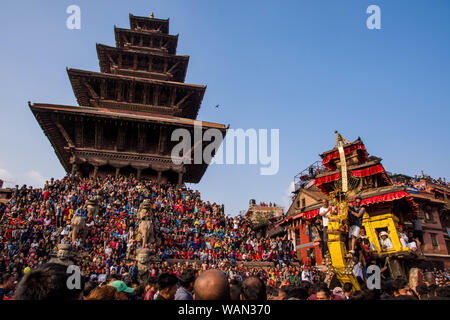 Hindu devotees pull a chariot in celebrations to mark Bisket Jatra festival offering prayers to Lord Bhairab and Goddness Bhadrakali in Bhaktapur. Stock Photo