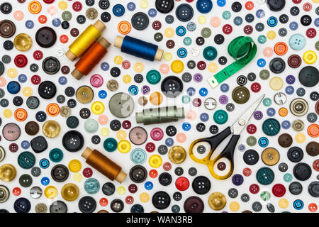 background - multicolored buttons and accessories for sewing on a white surface Stock Photo