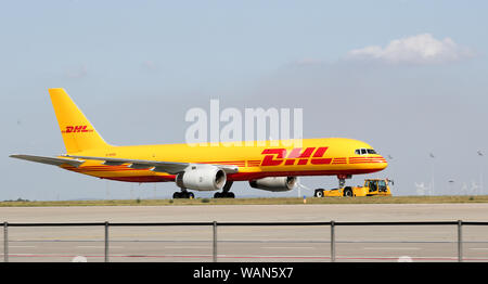 Schkeuditz, Germany. 21st Aug, 2019. A DHL cargo aircraft is towed to an apron position at Leipzig-Halle Airport. Credit: Jan Woitas/dpa-Zentralbild/dpa/Alamy Live News Stock Photo