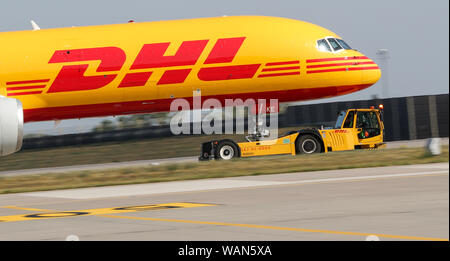 Schkeuditz, Germany. 21st Aug, 2019. A DHL cargo aircraft is towed to an apron position at Leipzig-Halle Airport. Credit: Jan Woitas/dpa-Zentralbild/dpa/Alamy Live News Stock Photo