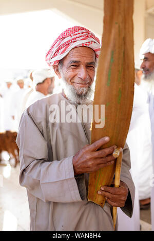 Portrait of a man with a beard and mustache in traditional clothes wearing a head scarf at Sinaw market, Oman Stock Photo