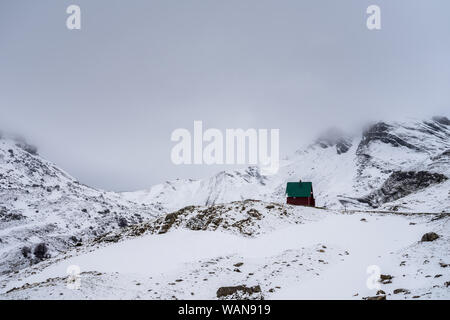 Montenegro, Winter snowscape and lonely alpine hut in snow covered durmitor national park mountains nature landscape in spring in may near zabljak Stock Photo