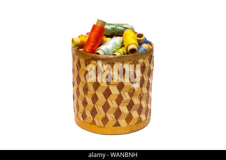 braided manually birchbark cylindrical box with spools of colored threads isolated on white background Stock Photo