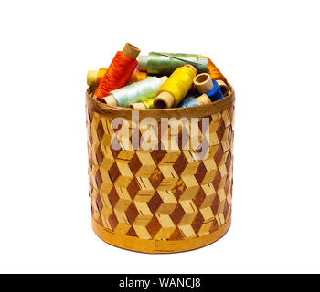 braided manually birchbark cylindrical box with spools of colored threads isolated on white background Stock Photo