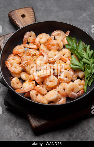 Beer snacks on stone background. Grilled shrimps Stock Photo