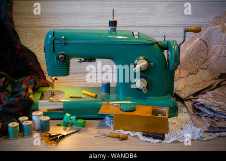 still life with vintage electric sewing machine and a variety of sewing accessories Stock Photo