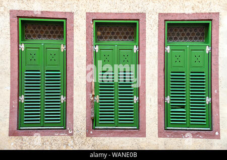 row of German house windows with bright green shutters Stock Photo