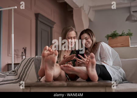 girls on couch Stock Photo