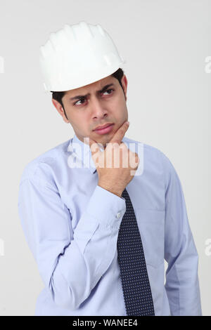Architect thinking with his hand on chin Stock Photo