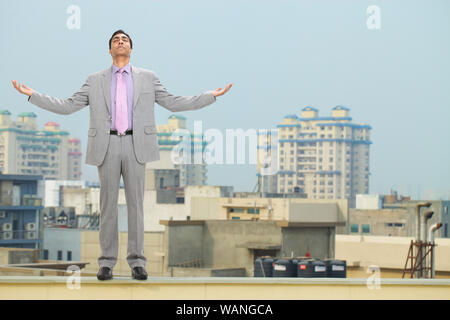 Businessman standing with his arm outstretched Stock Photo