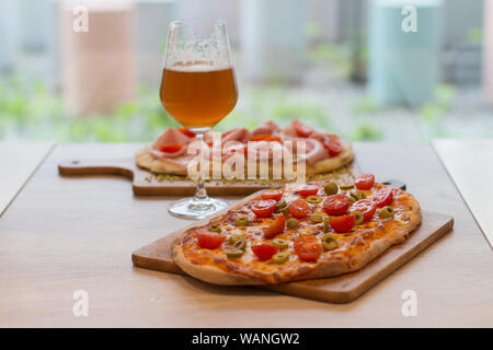 Italian happy hour food detail with pizza and beer glass Stock Photo