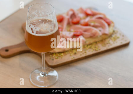 Italian happy hour food detail with pizza and beer glass Stock Photo