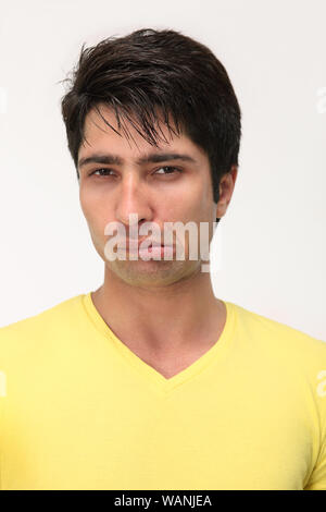 Portrait of an Indian young man grimacing towards camera Stock Photo