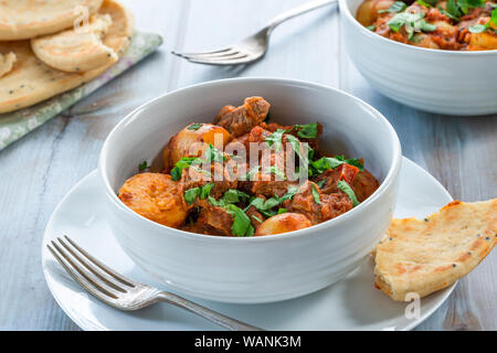 Aloo gosht with naan bread - lamb and potato curry - cuisine popular in Pakistan, Bangladesh and North India Stock Photo