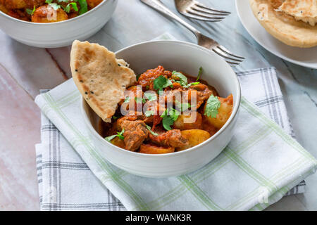 Aloo gosht with naan bread - lamb and potato curry - cuisine popular in Pakistan, Bangladesh and North India Stock Photo