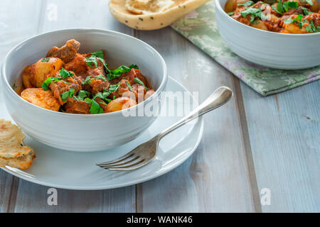 Aloo gosht with naan bread - lamb and potato curry - cuisine popular in Pakistan, Bangladesh and North India Stock Photo