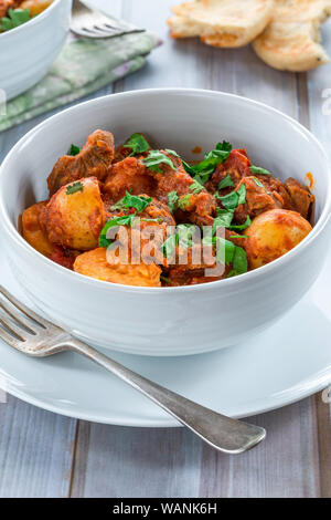 Aloo gosht with naan bread - lamb and potato curry - cuisine popular in Pakistan, Bangladesh and North India Stock Photo