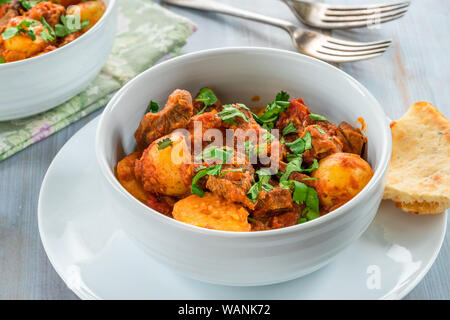 Aloo gosht with naan bread - lamb and potato curry - cuisine popular in Pakistan, Bangladesh and North India Stock Photo