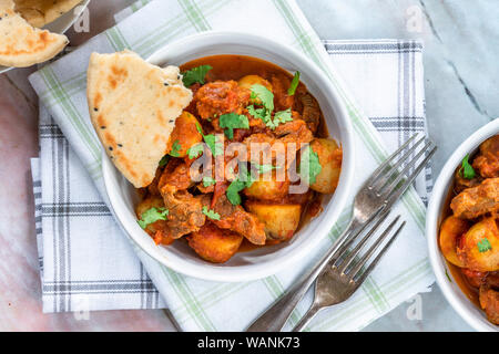 Aloo gosht with naan bread - lamb and potato curry - cuisine popular in Pakistan, Bangladesh and North India Stock Photo