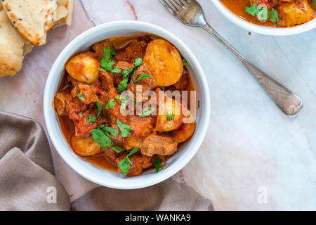 Aloo gosht with naan bread - lamb and potato curry - cuisine popular in Pakistan, Bangladesh and North India Stock Photo